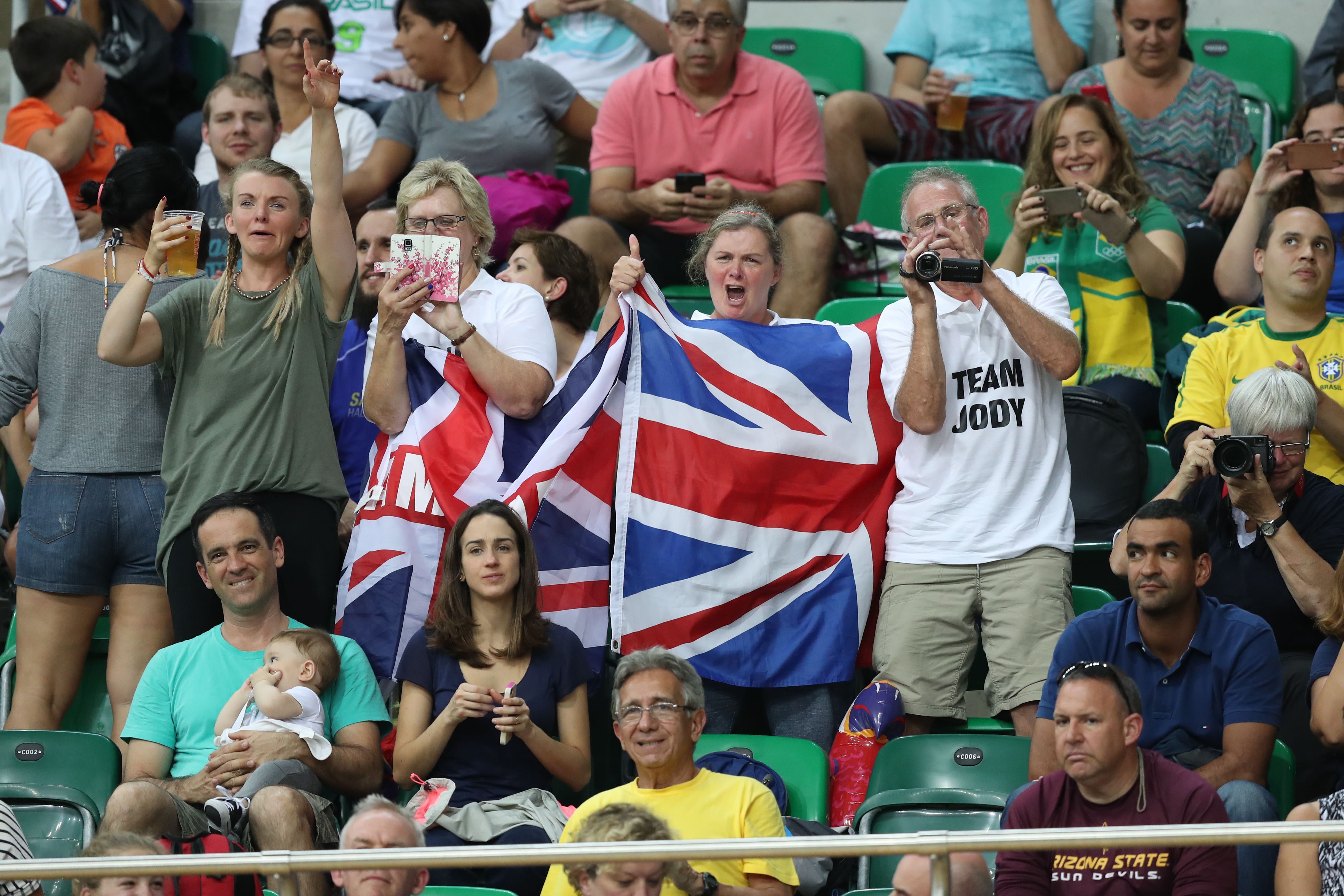 ジョディコンデの両親は白いポロシャツを着て、世界中で息子のスポーツのキャリアを続けてきました